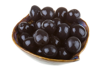 Olives black watered with olive oil in a bowl isolated on a whit