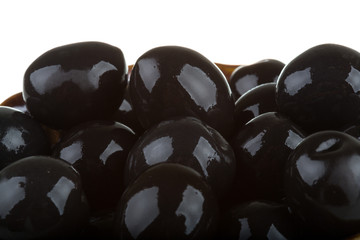 Olives black watered with olive oil in a bowl isolated on a whit