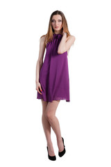 Beautiful female fashion model posing in purple dress