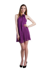 Beautiful female fashion model posing in purple dress
