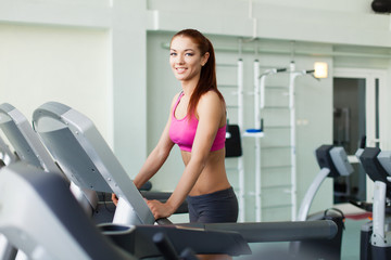 Fototapeta premium fitness model runs on treadmill is engaged in fitness sport club