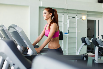 Fototapeta premium fitness model runs on treadmill is engaged in fitness sport club