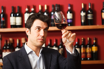 Sommelier examining a glass of red wine