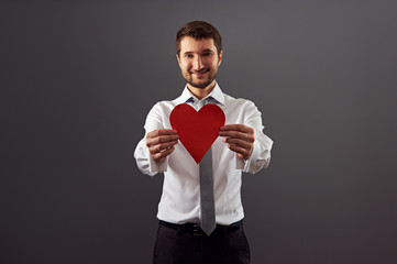 handsome man showing red heart