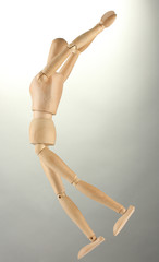 wooden mannequin, on grey background