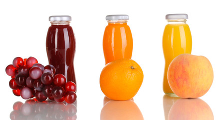 Delicious grapes, orange and apple juice in glass bottle and