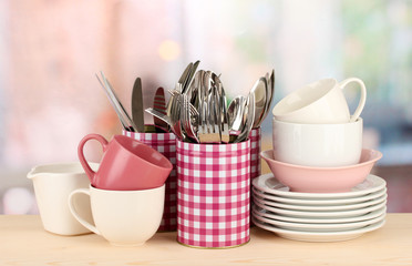 Cups, bowls nd other utensils in metal containers isolated