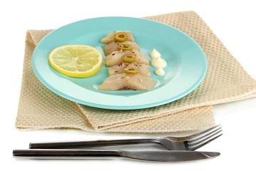 Dish of herring and lemon on plate isolated on white