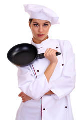 Portrait of young woman chef with flying pan isolated on white