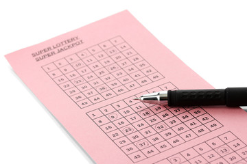 Lottery ticket and pen, isolated on white