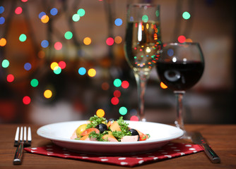 Tasty salad on dark background with bokeh  defocused lights