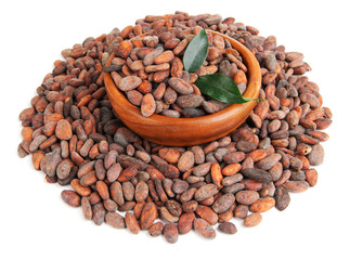 Cocoa beans in bowl with leaves, isolated on white