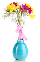 Beautiful bouquet of freesia in vase isolated on white