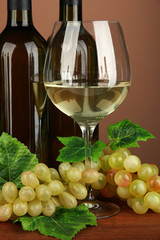 Composition of wine bottles, glass of white wine, grape