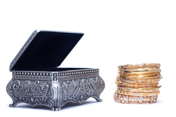 isolated of luxury gold bracelet with an opened silver chest