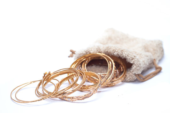 isolated of so many luxury gold jewellery bracelet on pouch