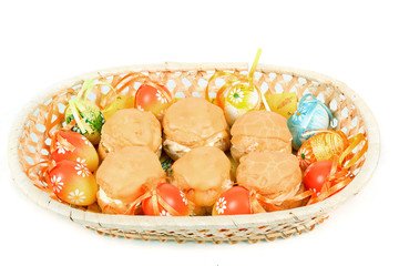 easter eggs and homemade sweet cakes in basket