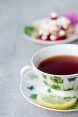 Closeup on sweet cake with cup of tea on wooden table