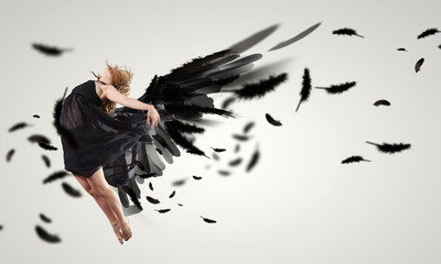 Woman floating   on dark wings