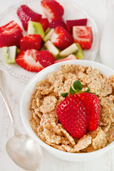 cereals with strawberry in white bowl