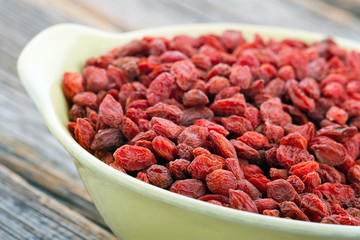 Dried goji berries in a yellow bowl