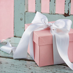 Pink present on a blue wooden chair
