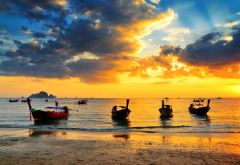 Traditional thai boats at sunset beach