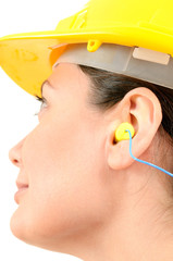 Woman with protective equipment and ear plugs