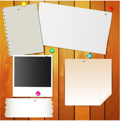 paper and stationery needles on the wall of wood