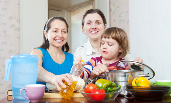  happy women with child  in kitchen