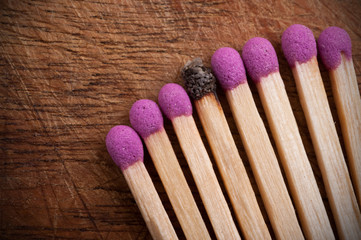 Group of matchsticks and a used one.