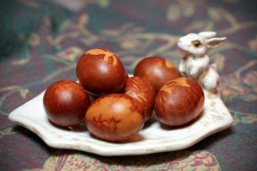 Easter eggs colored with natural color, on bunny rabbit plate