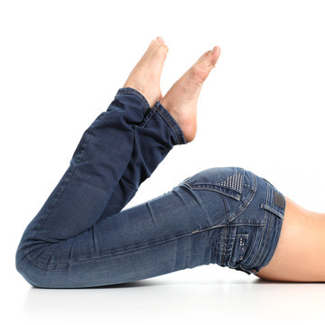 Close up of a beautiful woman legs with jeans and barefoot