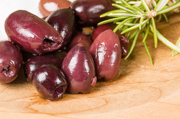 Kalamata olives and rosemary being prepared