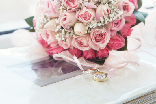 diamond & gold  wedding ring on a photo album