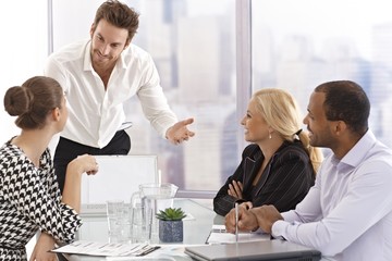 Young businessman presenting to partners