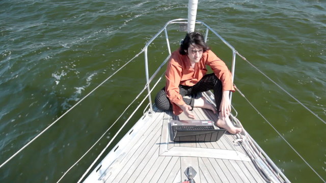 With laptop on a yacht