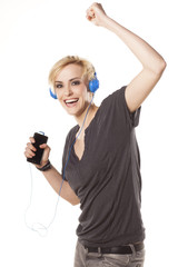 happy blonde plays with headphones and music from her phone