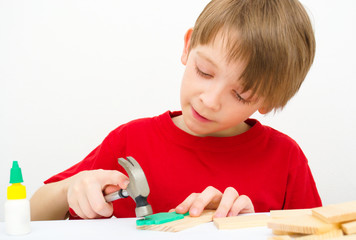 Boy working with hammer and nail