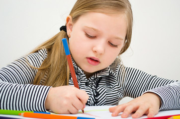 Portrait of girl drawing with colorful pencils