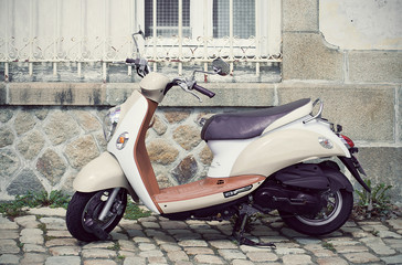 scooter motorcycle parked in the street