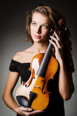 Fototapeta na wymiar Woman performer with violin in studio