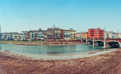 Parma river with houses and bridge in winter day