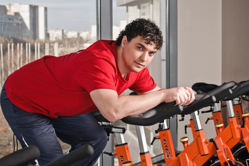 young man on exercise bicycle