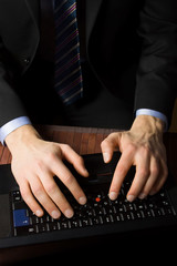 Businessman typing on a Personal Computer keyboard
