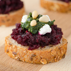 beet salad with pesto and goat cheese on toasted grain breads