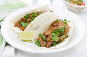 chili con carne in wheat tortillas on a plate horizontal