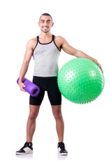 Man with swiss ball doing exercises on white