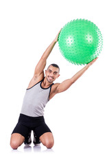 Man with swiss ball doing exercises on white