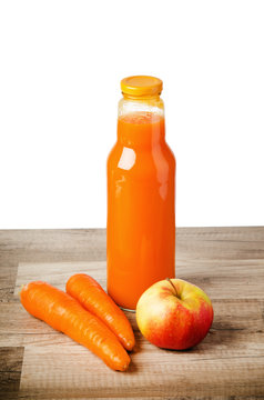 Bottle with carrots juice and an apple
